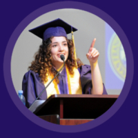 Student speaker at podium in regalia