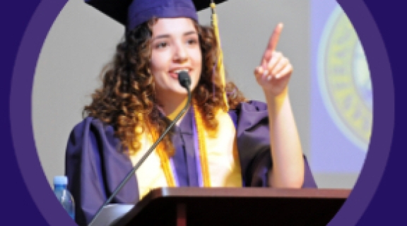 Student speaker at podium in regalia